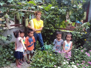 Teacher Nora of the Sawang Calero daycare center shows off her prize "upo" from the center's backyard vegetable garden.