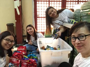 Ms Phi Anh and the younger members of Project Ki.D.S packing donations for Gota de Leche beneficiaries